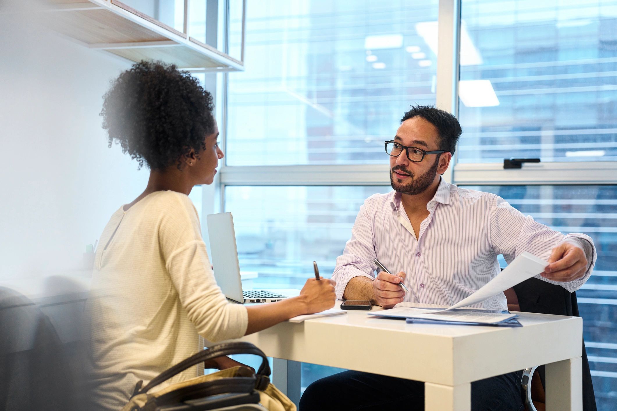 Financial advisor meeting with a client in an office