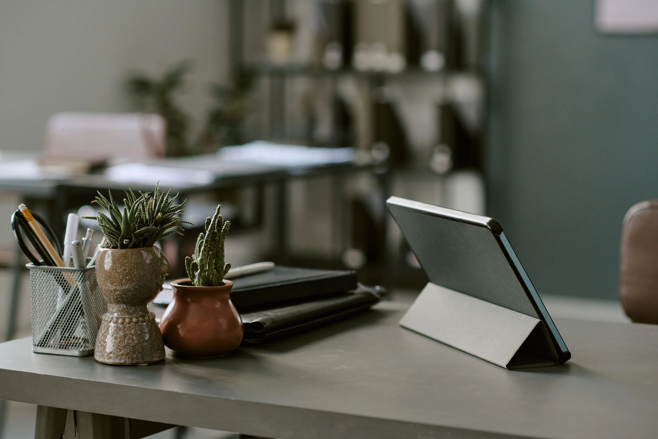 Organized finance workspace with tablet, notebook, and desk accessories